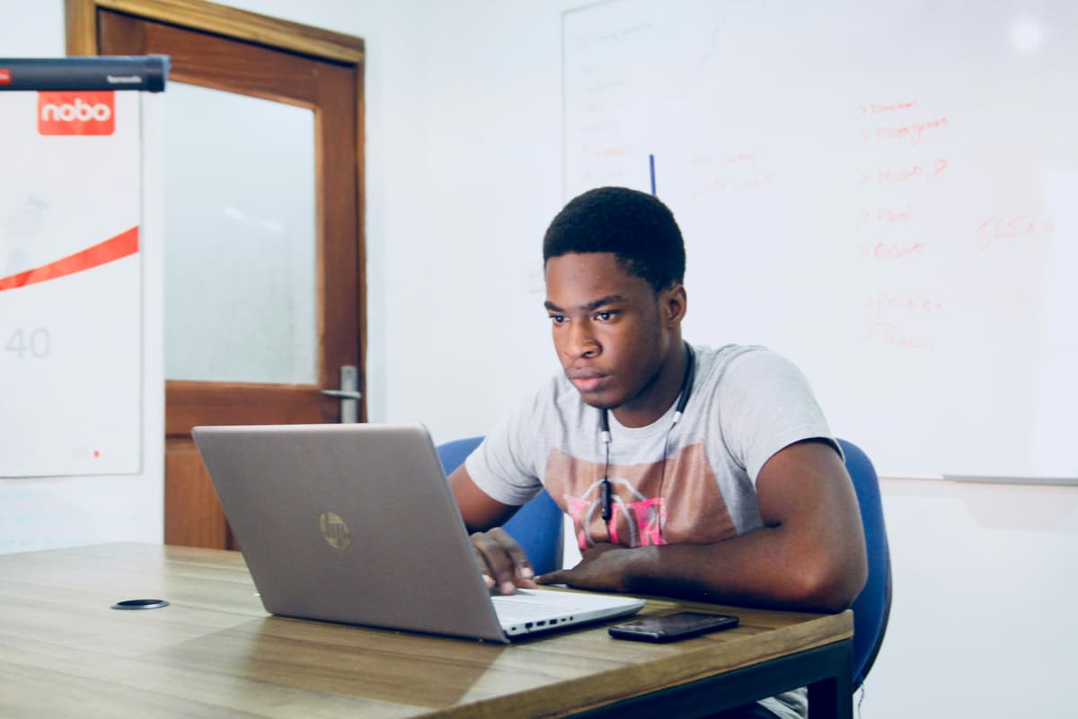 Student engaged in online tutoring session with laptop
